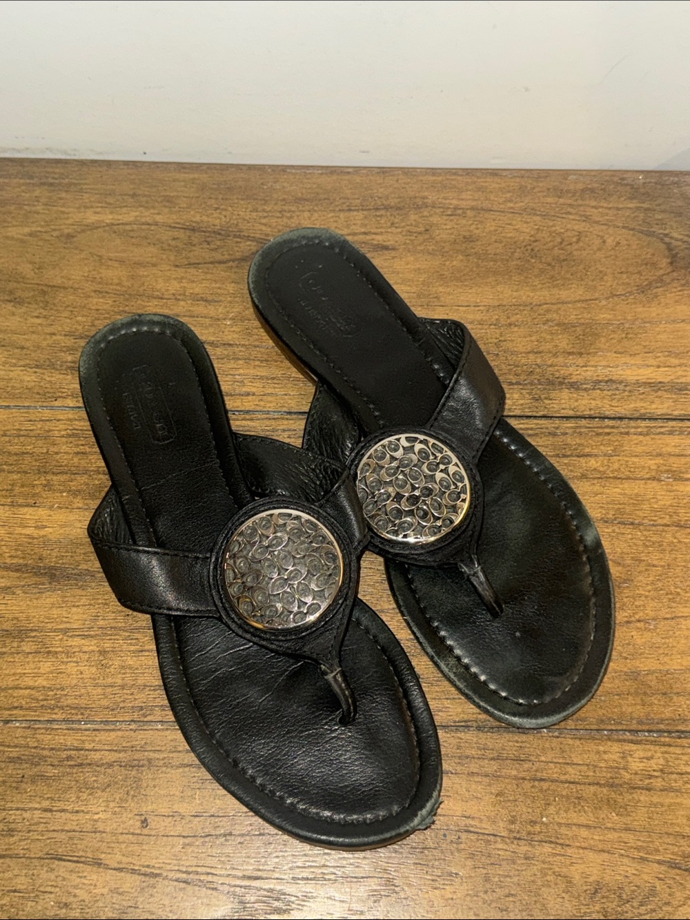 Coach Black Leather Thong Sandals with Decorative Silver Medallions